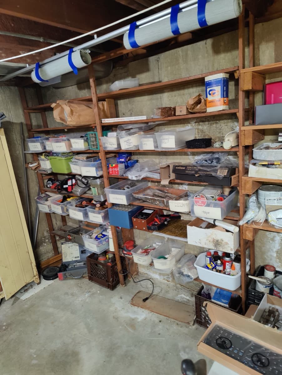 Storage shelves filled with household items before the property transition